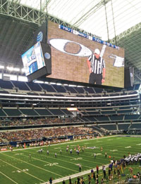 Sasser makes an announcement in a college game at AT&T Stadium.